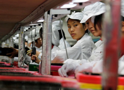 Workers are seen inside a Foxconn factory in the township of Longhua in the southern Guangdong province